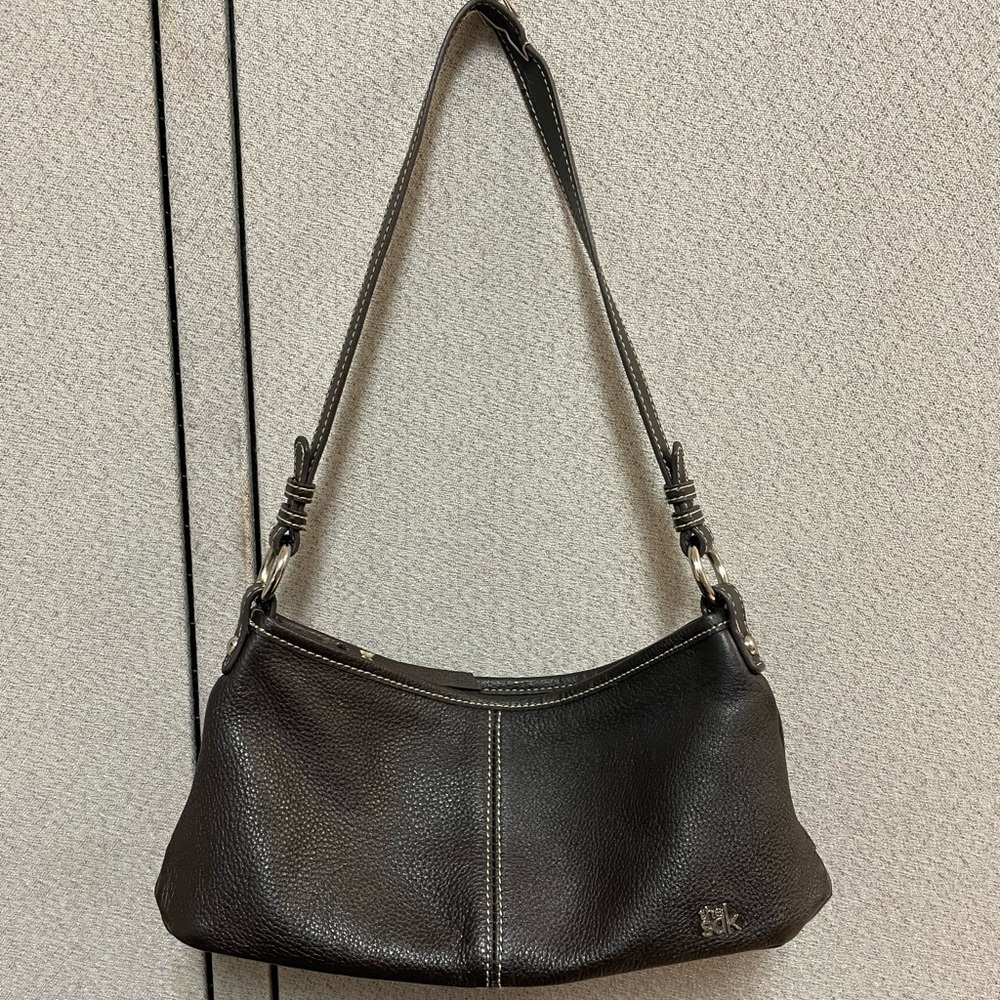Small to medium black leather The Sak shoulder purse